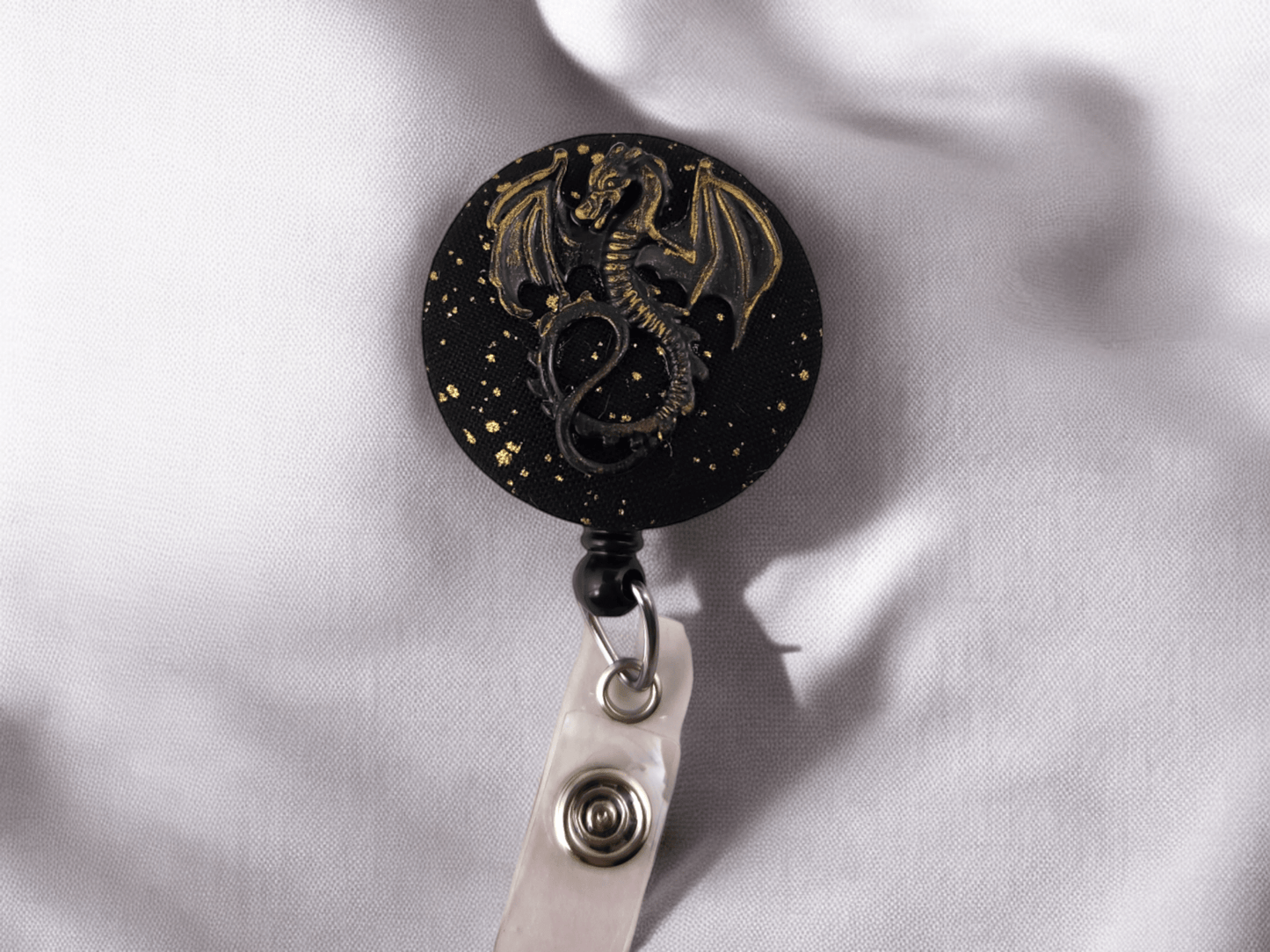 Black and gold dragon badge reel - Rowan Gate