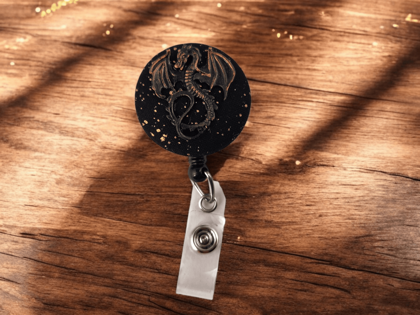 Black and gold dragon badge reel - Rowan Gate