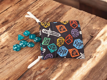 Mini drawstring bag with a set of mini dice, light teal with some glimmer. - Rowan Gate