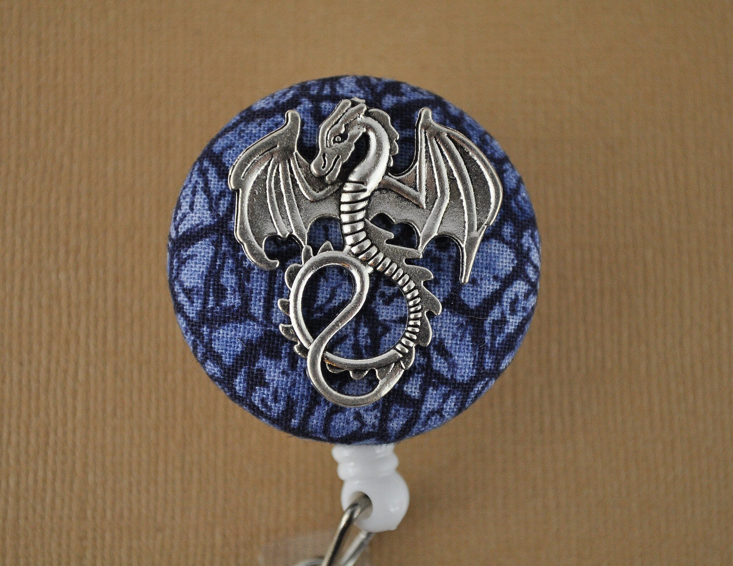 Silver dragon on blue scales badge reel - Rowan Gate