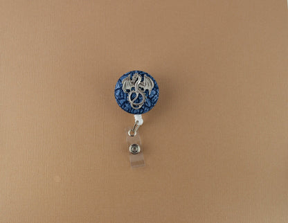 Silver dragon on blue scales badge reel - Rowan Gate